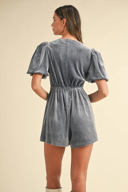 Back view of a gray velvet bow romper for women with puff sleeves and elastic waistband