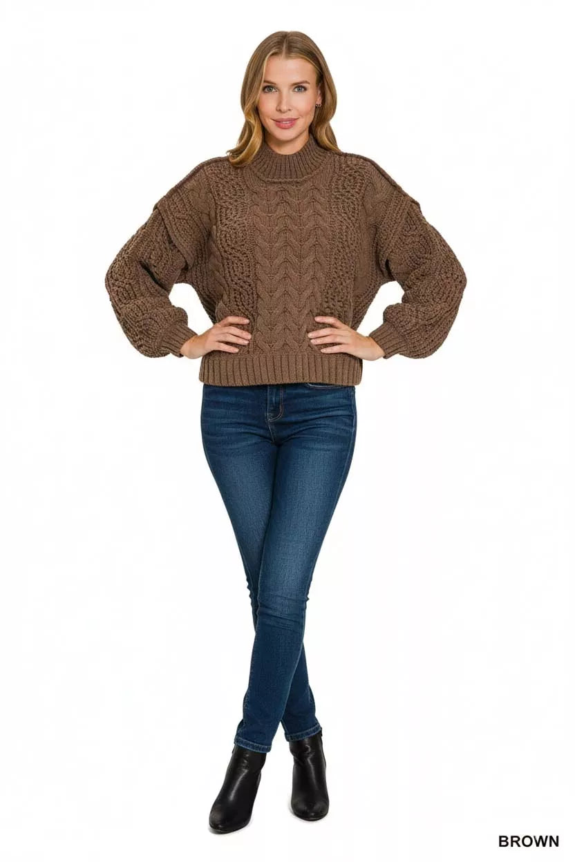 Brown cable knit turtleneck sweater with oversized sleeves styled with jeans