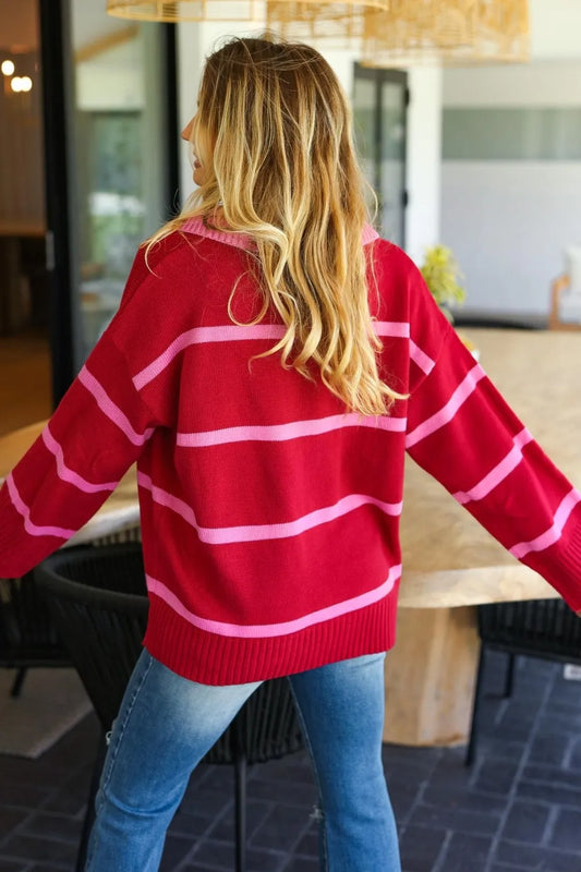 Back view of a woman wearing a collared striped boho sweater in red and pink stripes