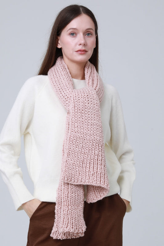 Soft pink chunky ribbed scarf for women styled with a cream sweater for a cozy look