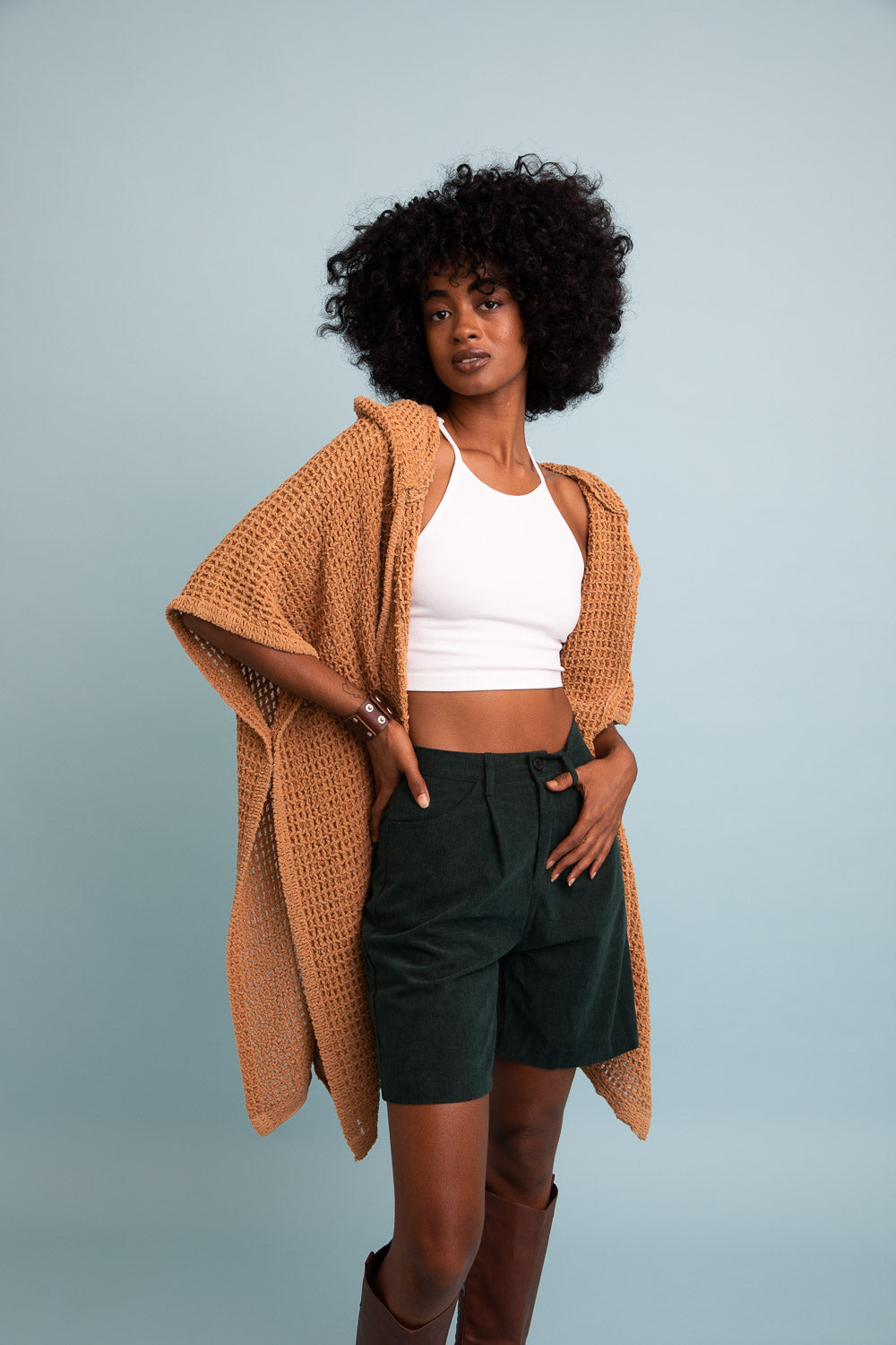 Leto Collection boho waffle ruana with hood in tan color styled over a white crop top and green shorts