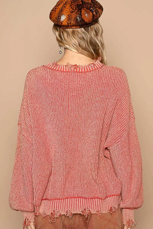 Back view of a boho distressed sweater for women in pink with a relaxed fit and fringe detailing