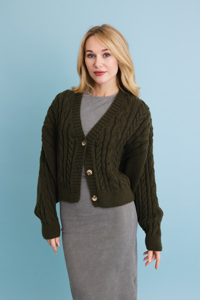 Chunky cable knit cropped cardigan in olive green for stylish layering in cooler weather