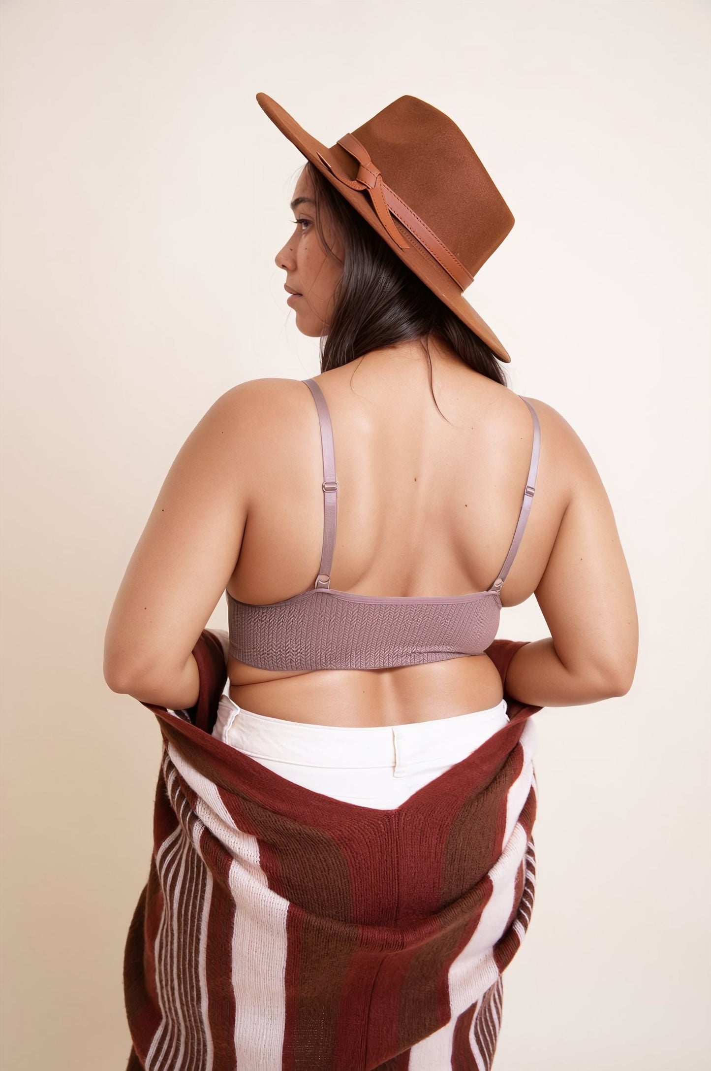 Plus size lace brami in soft fabric with adjustable straps and a ribbed design, styled with a hat