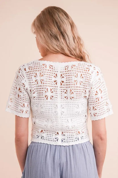 White crochet front tie crop top with detailed floral pattern for a stylish summer look