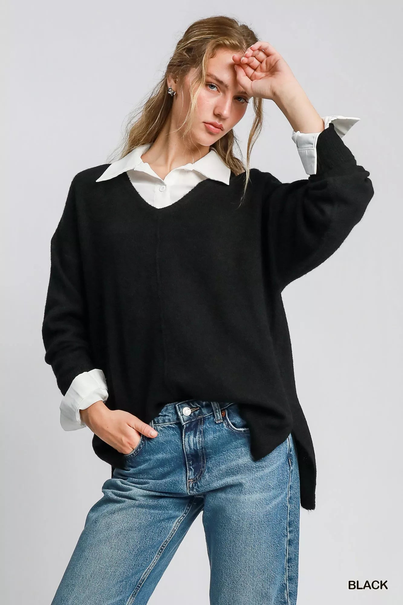 Umgee wool blend pullover sweater in black worn over a white shirt with casual denim jeans