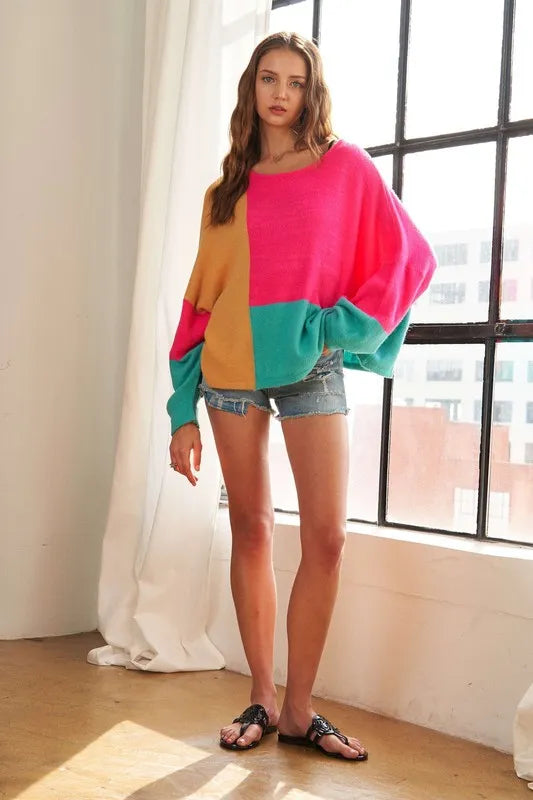 Trendsi boho colorblock sweater in pink, turquoise, and tan, paired with denim shorts