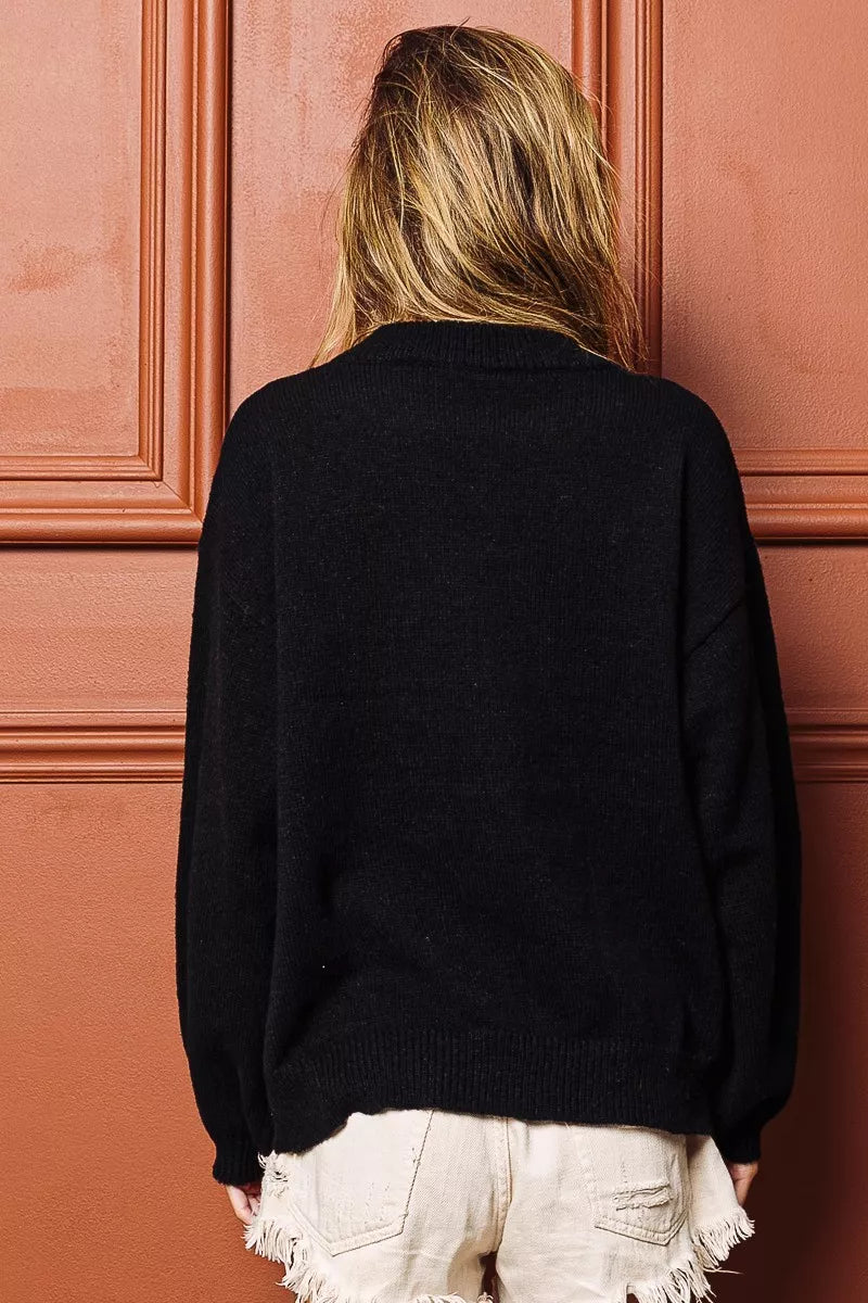 Cozy black tinsel lettering Christmas sweater with a relaxed fit for festive holiday celebrations