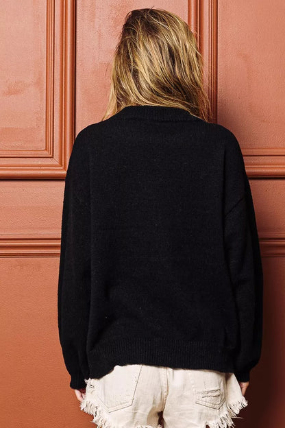 Cozy black tinsel lettering Christmas sweater with a relaxed fit for festive holiday celebrations