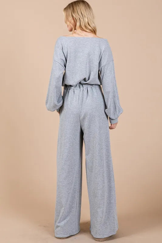 Back view of a gray boho long sleeve jumpsuit with relaxed fit and wide-leg pants