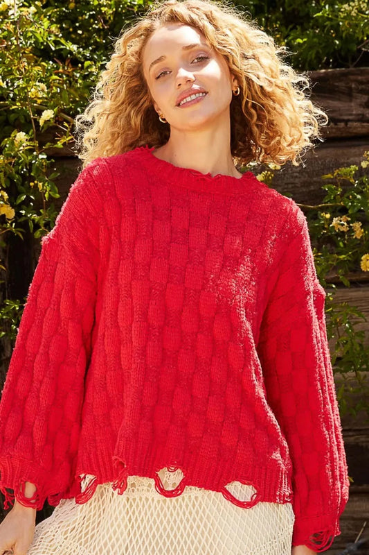 Boho checkered distressed sweater in vibrant red with a cozy oversized fit and unique textured pattern