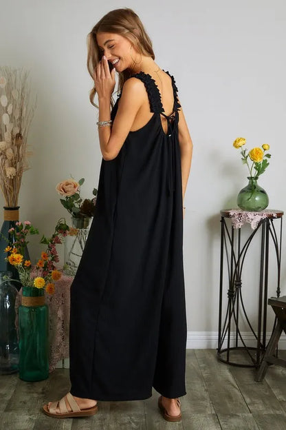 Plus size boho jumpsuit in black with a stylish back tie and floral accents, perfect for casual outings