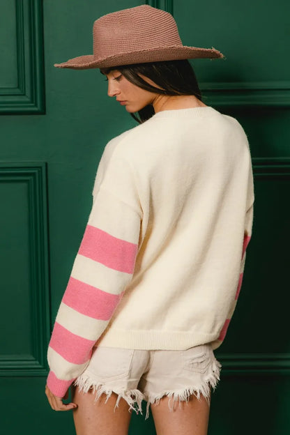 Colorful floral sweater for women with contrasting pink stripes and relaxed fit