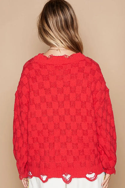 Back view of a red boho checkered distressed sweater with a loose fit and textured design