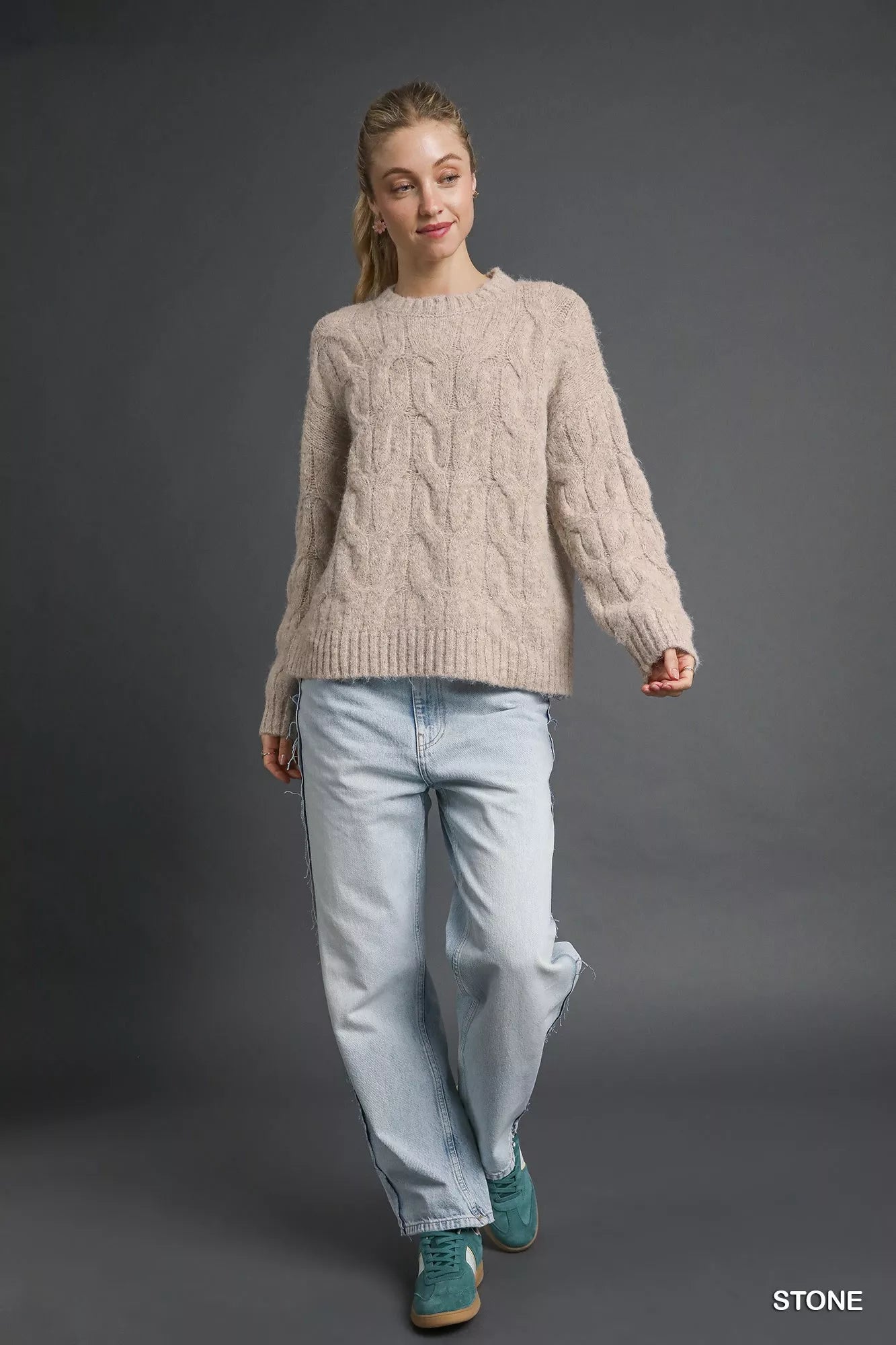 Umgee cable knit sweater in stone color paired with light blue jeans for a cozy look