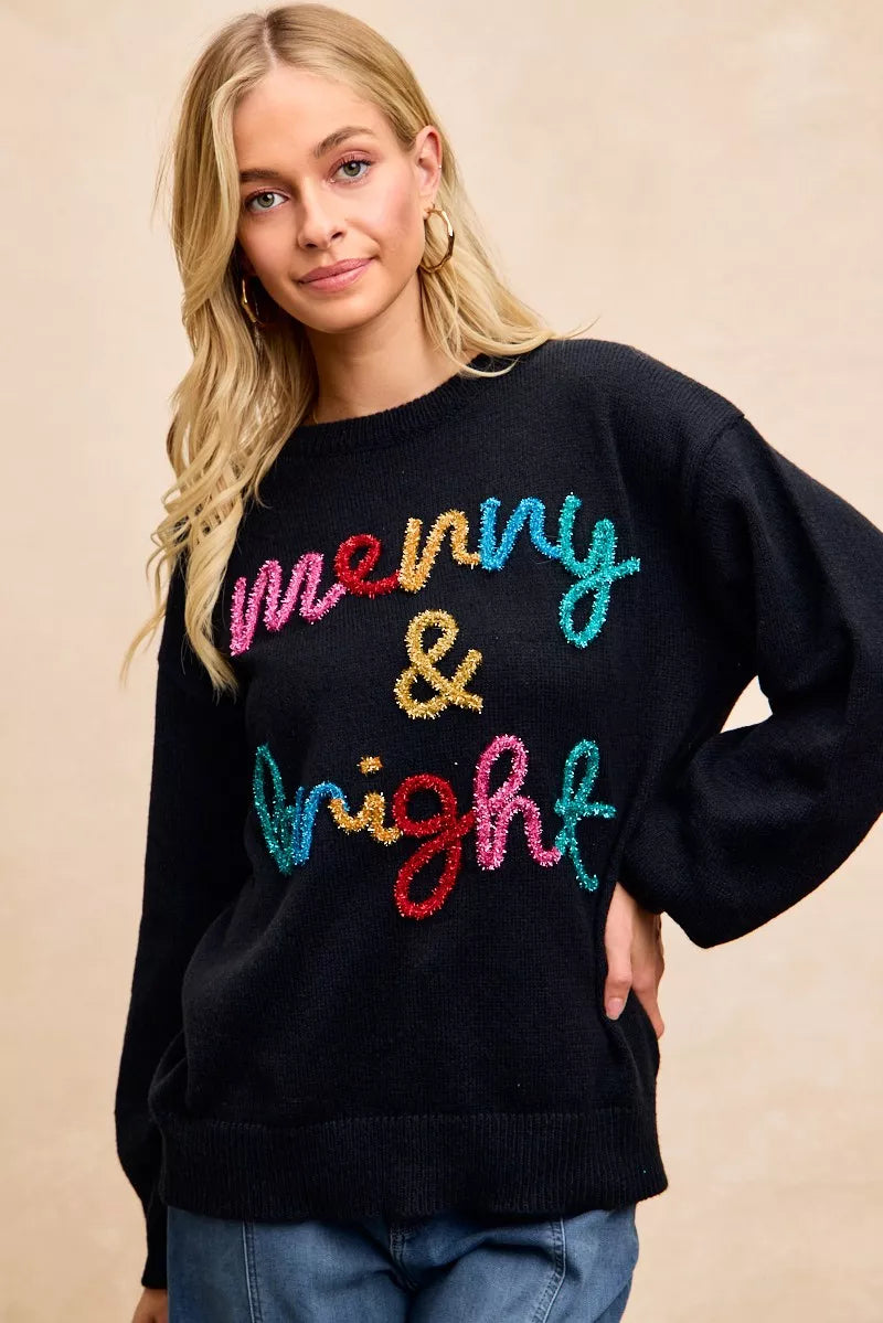 Women’s black tinsel lettering Christmas sweater featuring colorful 'Merry & Bright' design