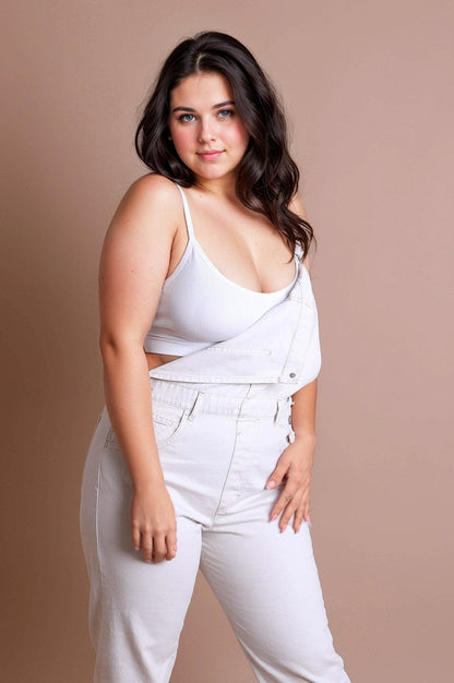 Plus size low back bralette in white worn with light denim overalls for a trendy look