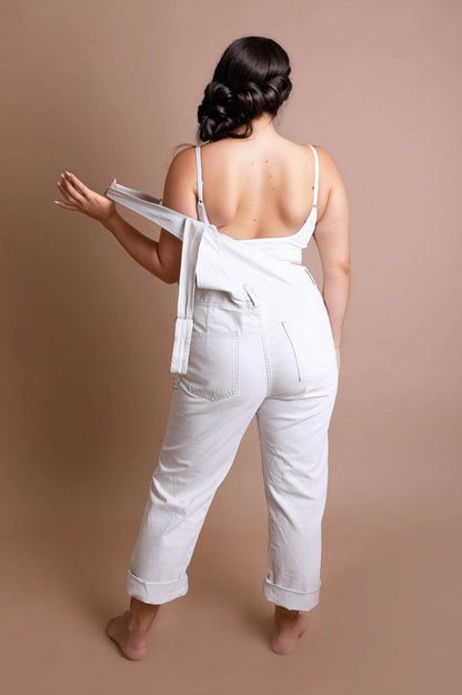 Plus size low back bralette paired with stylish white high-waisted jeans for a chic look
