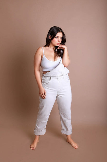 Model in a casual outfit featuring a plus size low back bralette and light-colored tapered jeans