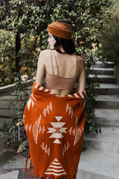 Leto Collection offset shoulder brami top in nude worn with a patterned orange shawl outdoors
