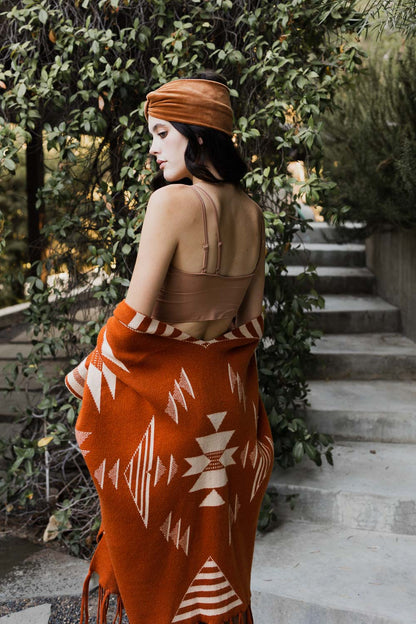 Leto Collection offset shoulder brami top in soft fabric, styled with an orange shawl outdoors
