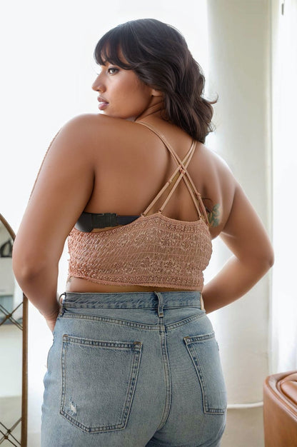 Back view of a plus size crochet bralette in soft fabric with adjustable straps, paired with high-waisted jeans
