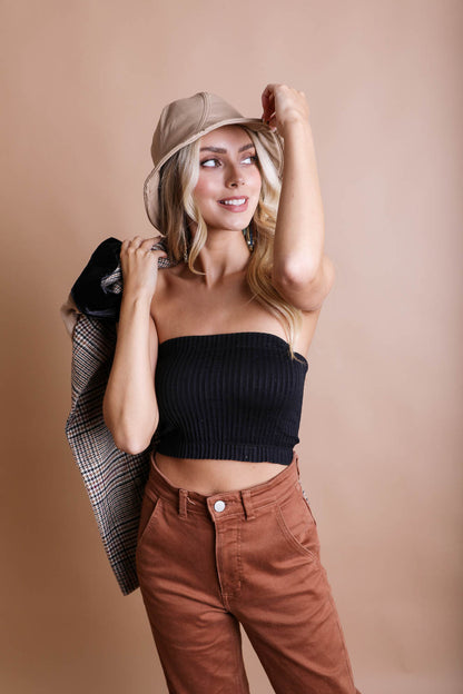 Stylish woman wearing a black bralette and tan pants, showcasing a boho bandeau top look