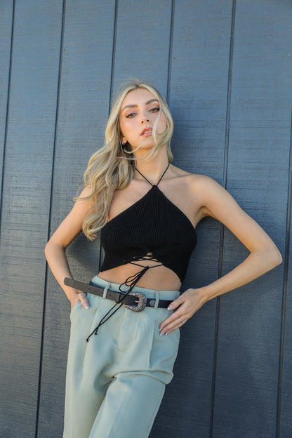 Model wearing a western style fashion belt with a stylish top and high-waisted pants