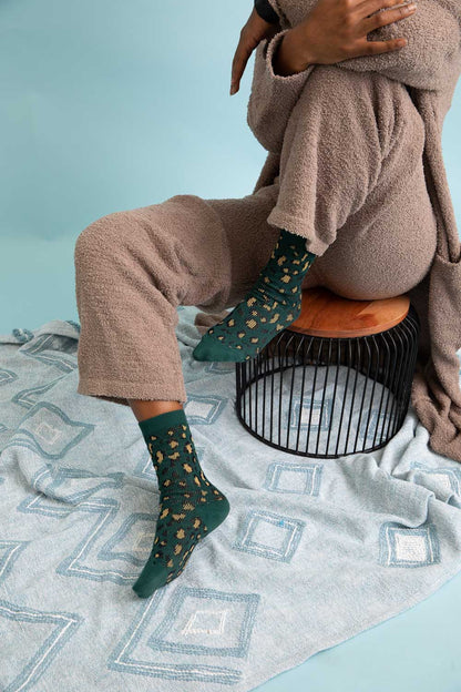 Cozy Leto Collection leopard knit socks in green, perfect for lounging at home