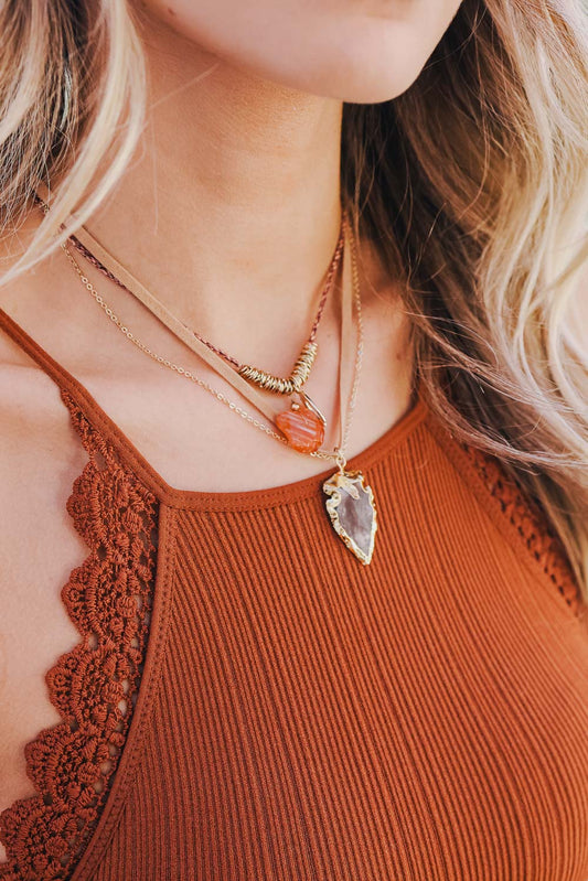 Leto Collection layered gold Boho Necklace, Boho Chic Jewelry, Spiritual with orange bead and druzy arrowhead pendant on model