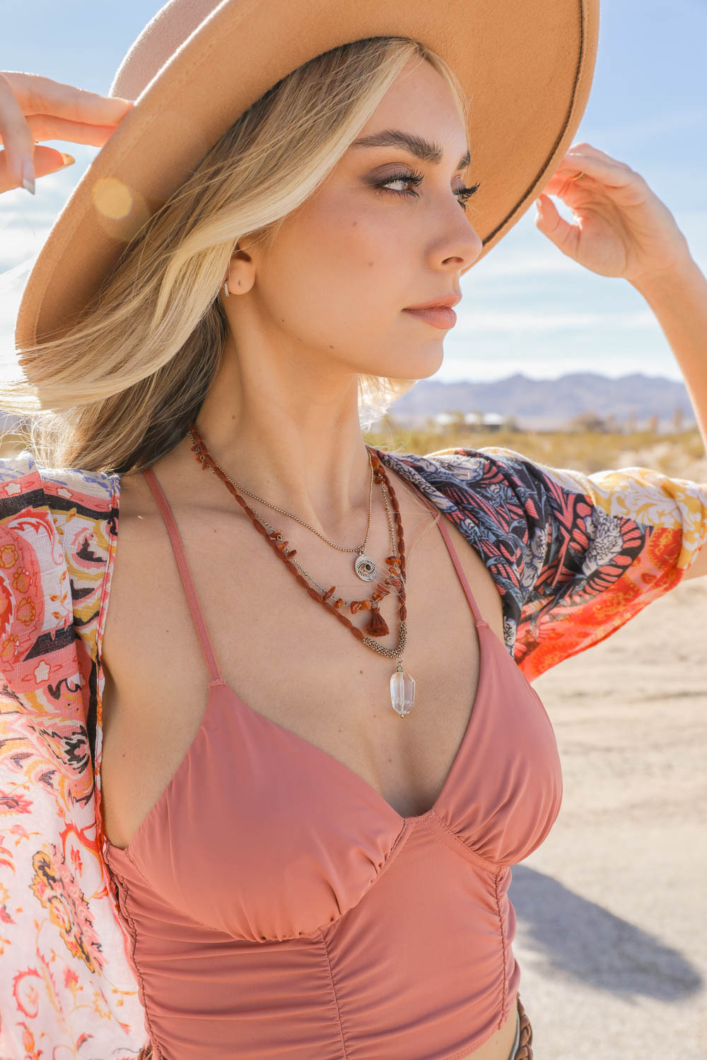 Leto Collection model wearing layered Boho Necklace, Boho Chic Jewelry, Spiritual beaded necklaces with crystal pendant and hat