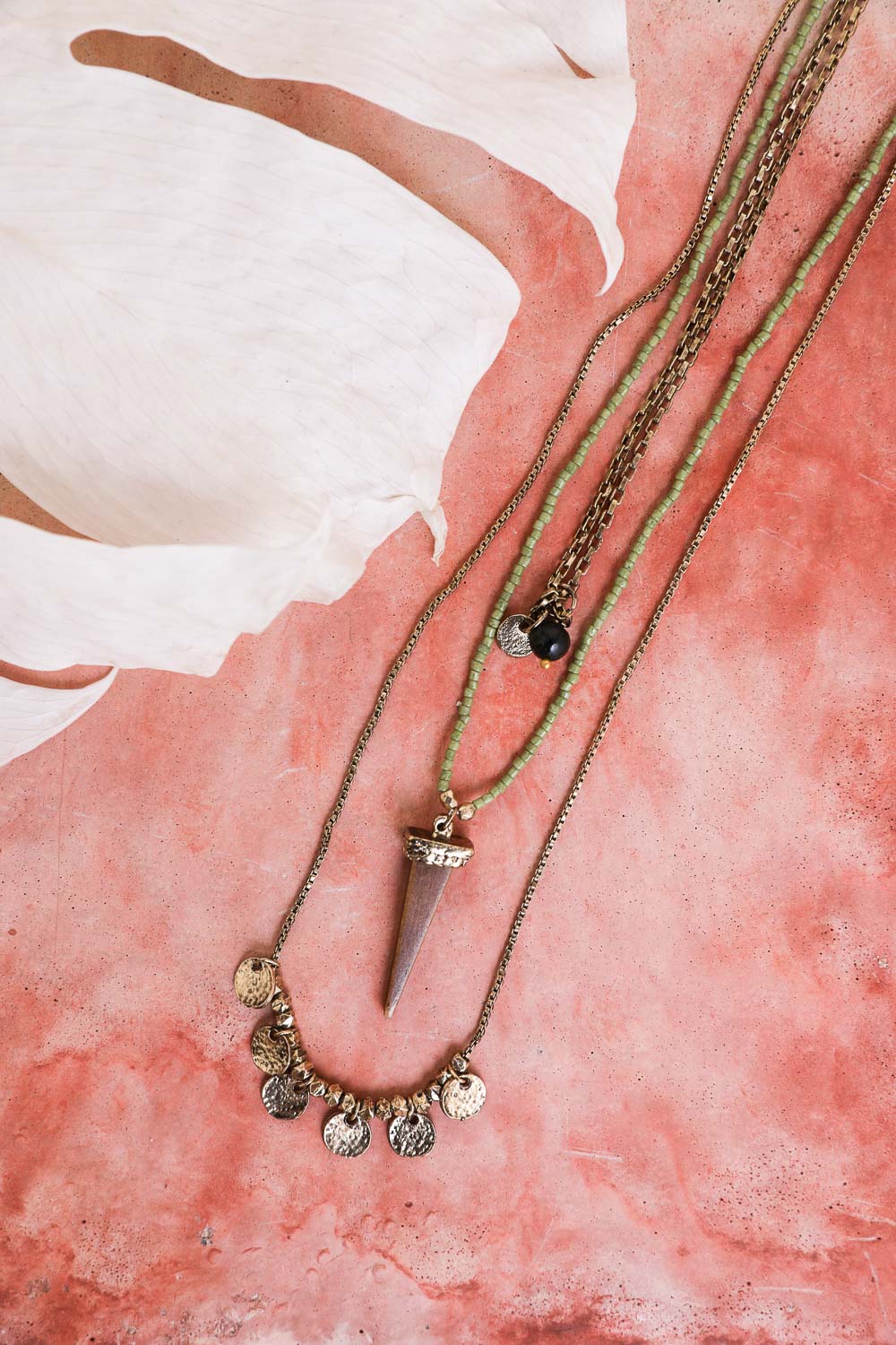 Leto Collection layered Boho Necklace, Boho Chic Jewelry, Spiritual stone pendant with coin charm necklaces on pink background