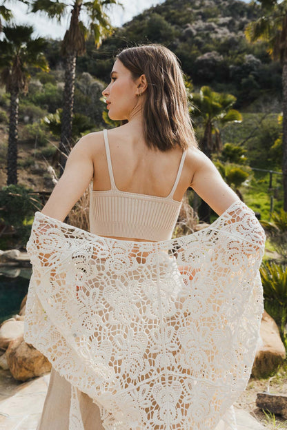 Model wearing a rib knit lounge brami shown with a flowy lace shawl in a scenic outdoor setting
