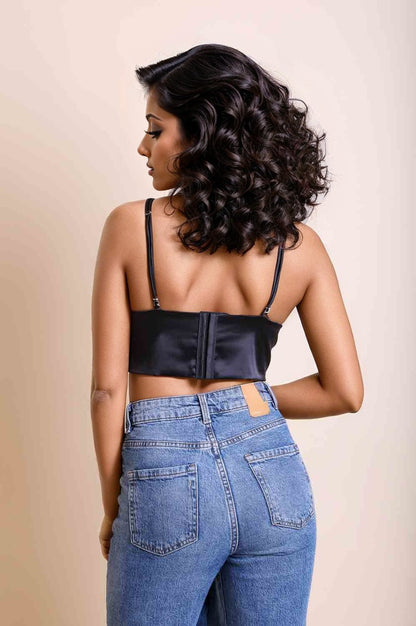 Elegant satin longline bralette in black showcasing a stylish back design and paired with high-waisted jeans
