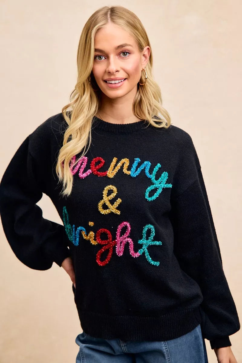 Cozy black Christmas sweater with tinsel lettering Christmas sweater design saying 'Merry & Bright'