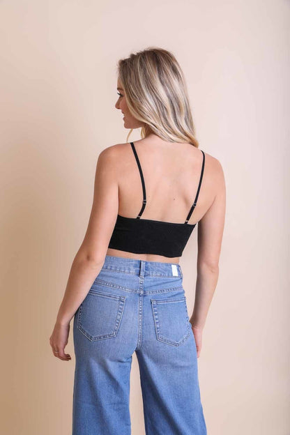 Back view of a woman wearing a stretchable brami top for women paired with high-waisted jeans