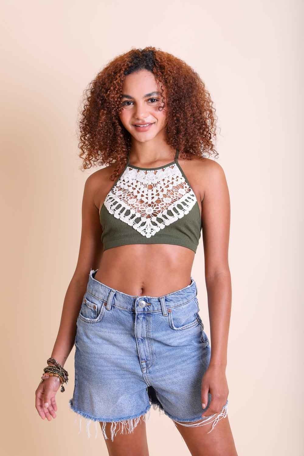 Olive green crochet lace high neck bralette styled with denim shorts for a chic look