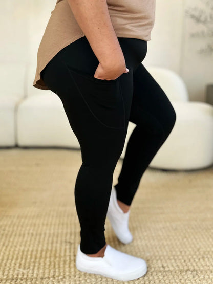 Comfortable black wide waistband sports leggings with side pockets for activewear enthusiasts