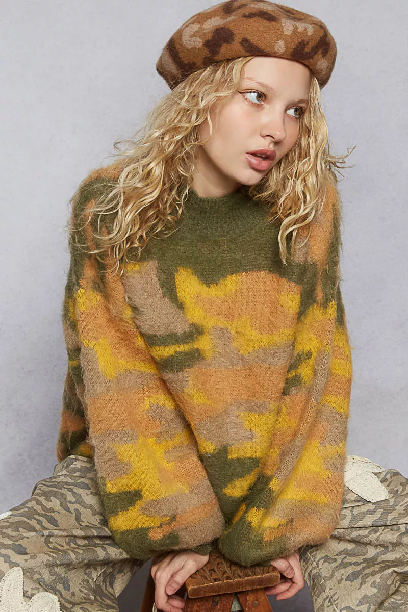 Women wearing an abstract colorblock sweater with green, yellow, and brown hues for a trendy look