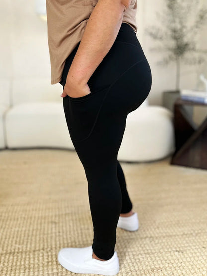 Black wide waistband sports leggings with pockets and a comfortable fit for active wear