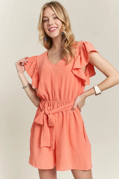 Trendsi boho ruffle sleeve romper in coral with a tie waist and flirty sleeves for a stylish summer look
