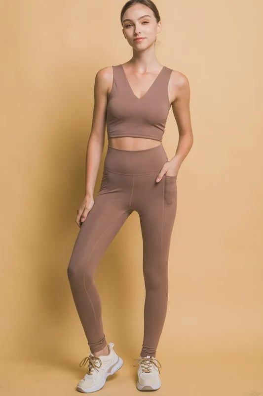 Trendy brown high waist leggings with pockets paired with a matching crop top for activewear style