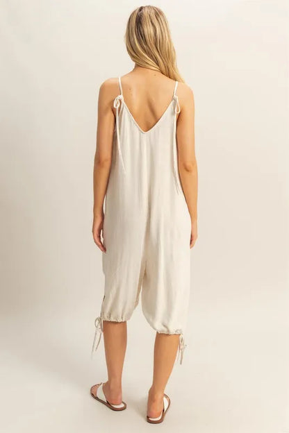 Trendsi boho v-neck romper with pockets in cream color featuring a tie-back design