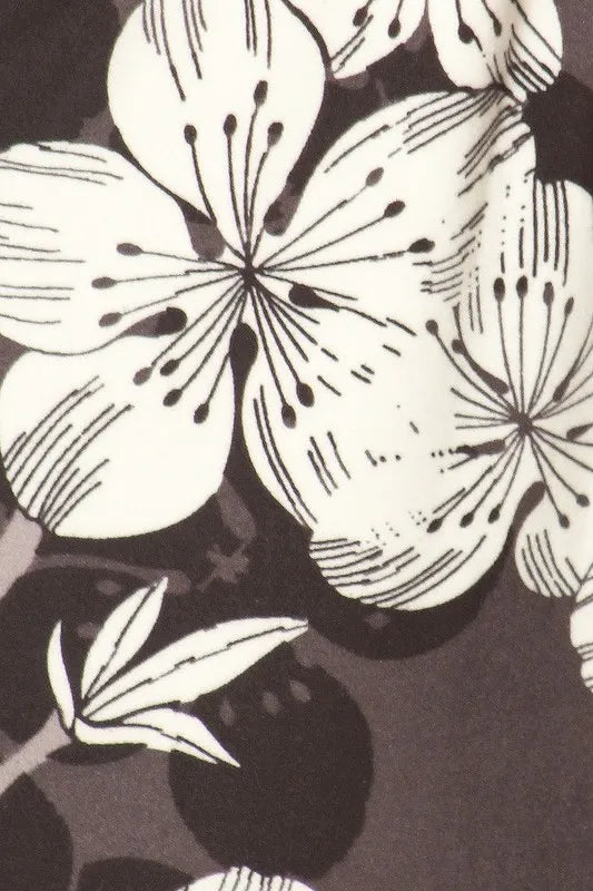 Close-up of the buttery soft floral joggers featuring elegant black and white flower patterns