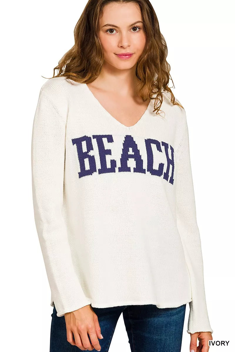 Trendsi Boho Beach V Neck Sweater in Ivory with 'BEACH' lettering for a relaxed, trendy look