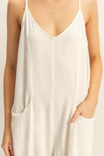 Trendsi boho v-neck romper with pockets in beige, featuring a relaxed fit and stylish design for effortless summer wear