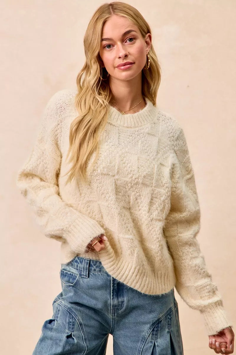Cream checker board drop shoulder sweater with a cozy, textured knit design for stylish layering