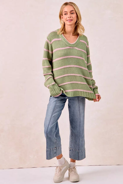 Boho striped long sleeve sweater in green with pink stripes, paired with cropped jeans and sneakers