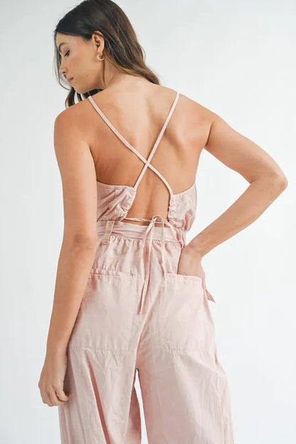 Back view of a pink Trendsi boho belted jumpsuit for women with adjustable straps and pockets