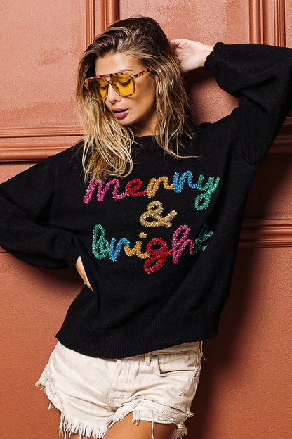 Trendsi tinsel lettering Christmas sweater in black with colorful 'Merry & Bright' design